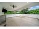 Outdoor patio with a ceiling fan, TV, stainless steel cabinets, and serene view of lush greenery at 32 Walthall Ne St # A, Atlanta, GA 30307