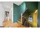 Staircase featuring modern railings, hardwood floors, and a designer green accent wall at 32 Walthall Ne St # A, Atlanta, GA 30307