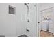 Modern bathroom with tiled shower and adjacent laundry area with washer and dryer at 3229 Kingsdale Dr # 2, Atlanta, GA 30311
