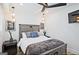 Bedroom with rustic wood bedframe, neutral bedding, and modern ceiling fan and lighting at 3229 Kingsdale Dr # 2, Atlanta, GA 30311