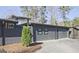 View of home exterior with brick and wood siding, neutral color scheme, and mature trees at 3229 Kingsdale Dr # 2, Atlanta, GA 30311