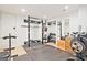 Bright home gym with weight rack, weights, black rubber mat flooring, and storage for accessories at 3229 Kingsdale Dr # 2, Atlanta, GA 30311