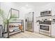 Modern kitchen with stainless steel appliances, sleek white cabinetry, and light wood floors at 3229 Kingsdale Dr # 2, Atlanta, GA 30311