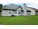 Exterior of home shows a spacious backyard, complete with an air conditioning unit and gray siding at 5502 Sapphire Cir, Ellenwood, GA 30294