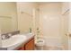 Bathroom featuring a sink with a vanity, toilet, shower, and white bathtub at 5502 Sapphire Cir, Ellenwood, GA 30294