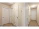 Hallway with neutral walls, carpeted floor, and multiple doors leading to rooms at 5502 Sapphire Cir, Ellenwood, GA 30294
