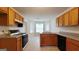 Kitchen with matching appliances, cabinetry, and a bay window in the breakfast nook at 5502 Sapphire Cir, Ellenwood, GA 30294