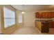 Bright kitchen eating area with laminate floors and natural light from two windows at 5502 Sapphire Cir, Ellenwood, GA 30294