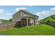 Large backyard with a covered patio and a wooden fence at 3711 Wartrace Dr, South Fulton, GA 30331