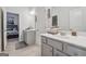 Bathroom features neutral-toned tiles, double sink vanity with mirrors, and easy bedroom access at 3711 Wartrace Dr, South Fulton, GA 30331