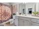 Bathroom featuring a flower-themed shower curtain, single vanity, and neutral-toned floor tiles at 3711 Wartrace Dr, South Fulton, GA 30331