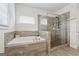 Clean bathroom with a tub, walk-in shower, and wood-look tile at 3711 Wartrace Dr, South Fulton, GA 30331