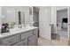 Bathroom with neutral palette, features vanity with framed mirror and easy access to the staircase at 3711 Wartrace Dr, South Fulton, GA 30331