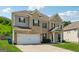 Attractive two-story home boasts a brick facade, gray siding, two-car garage and well-maintained landscaping on a sunny day at 3711 Wartrace Dr, South Fulton, GA 30331