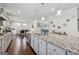 Large kitchen island featuring stainless steel appliances, granite countertops, and pendant lighting over dark hardwood floors at 3711 Wartrace Dr, South Fulton, GA 30331