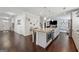 Spacious kitchen island with granite countertops, stainless steel appliances, and dark hardwood floors with an open concept design at 3711 Wartrace Dr, South Fulton, GA 30331