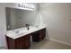 Bathroom featuring double sinks, a large vanity mirror with vanity lighting, and tile floors at 1238 Polk Xing, Mcdonough, GA 30252