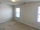 Bedroom featuring carpet flooring and multiple windows for natural light at 1238 Polk Xing, Mcdonough, GA 30252