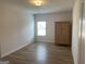 Bedroom featuring wood flooring, natural light, and closet with ample storage at 1238 Polk Xing, Mcdonough, GA 30252