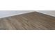 Close-up showcasing the new, light brown wood-look flooring throughout the home at 1238 Polk Xing, Mcdonough, GA 30252
