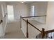 Hallway with carpet flooring and a wooden railing at 1238 Polk Xing, Mcdonough, GA 30252