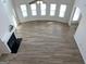 Living room area showing wood floors, a fireplace, and large windows allowing ample natural light at 1238 Polk Xing, Mcdonough, GA 30252