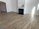 Living room featuring a classic fireplace with mantle and updated wood-look flooring at 1238 Polk Xing, Mcdonough, GA 30252