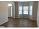 Bright living room with light walls, new wood-look flooring, and large bay windows at 1238 Polk Xing, Mcdonough, GA 30252