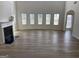 Bright living room featuring tall ceilings, wood floors, and a charming fireplace at 1238 Polk Xing, Mcdonough, GA 30252