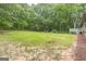 Large backyard with a spacious lawn and mature trees, offering privacy at 4023 Anvil Block Rd, Ellenwood, GA 30294
