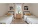 Cozy bedroom featuring two twin beds, symmetrical decor, and a natural color palette at 4023 Anvil Block Rd, Ellenwood, GA 30294