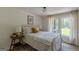 Bright bedroom with queen bed, bedside tables, and natural light from large windows at 4023 Anvil Block Rd, Ellenwood, GA 30294