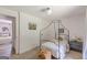 Cozy bedroom features a canopy bed, plush carpet, and a decorative woven ottoman and opens to another room at 4023 Anvil Block Rd, Ellenwood, GA 30294