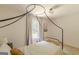 Bright bedroom boasts a metal canopy bed with window views, neutral carpet, and light walls providing a restful ambiance at 4023 Anvil Block Rd, Ellenwood, GA 30294