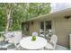 The home's deck features seating, a table and chairs, and provides access to the home at 4023 Anvil Block Rd, Ellenwood, GA 30294