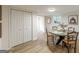 Bright dining area features a round table, modern lighting, and ample storage closet at 4023 Anvil Block Rd, Ellenwood, GA 30294