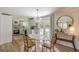 Dining room with a view into the kitchen and a sliding glass door to the patio with natural light and modern finishes at 4023 Anvil Block Rd, Ellenwood, GA 30294