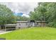 Single-story home with inviting front porch and meticulous landscaping nestled among mature trees at 4023 Anvil Block Rd, Ellenwood, GA 30294