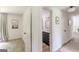 Hallway view leading to a bathroom featuring dark cabinets and modern fixtures at 4023 Anvil Block Rd, Ellenwood, GA 30294