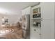 Kitchen view showcases stainless steel appliances, white cabinets, and adjacent dining area at 4023 Anvil Block Rd, Ellenwood, GA 30294