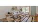Bright living room showcases neutral walls, hardwood floors, a decorative rug, and ample natural light at 4023 Anvil Block Rd, Ellenwood, GA 30294