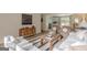 Open-concept living room boasts a wooden table, neutral sofa, decorative rug, and hardwood floors at 4023 Anvil Block Rd, Ellenwood, GA 30294