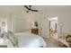 Cozy main bedroom featuring a ceiling fan, bedside tables, and a connecting door to another room at 4023 Anvil Block Rd, Ellenwood, GA 30294