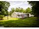 Spacious backyard with a well-maintained lawn, fencing, and a covered back porch at 155 Granby Ln, Fayetteville, GA 30215