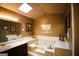 Bathroom featuring a soaking tub, a skylight, and decorative elements at 155 Granby Ln, Fayetteville, GA 30215