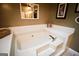 A luxurious soaking tub with tile surround and skylight to brighten the space at 155 Granby Ln, Fayetteville, GA 30215