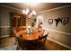 Traditional dining room featuring a wooden table with seating, a classic chandelier, and a wooden china cabinet at 155 Granby Ln, Fayetteville, GA 30215