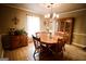 Traditional dining room featuring a wooden table with seating, a classic chandelier, and a wooden china cabinet at 155 Granby Ln, Fayetteville, GA 30215