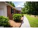Brick home exterior featuring manicured landscaping and a walkway at 155 Granby Ln, Fayetteville, GA 30215