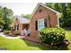 Quaint brick home with black shutters, a star decoration, and blossoming shrubbery at 155 Granby Ln, Fayetteville, GA 30215